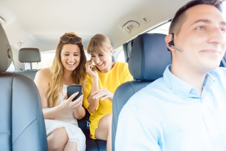 Canva-Girlfriends-Using-Their-Phones-on-Backseat-of-Taxi-scaled-compressor-1024x683-1